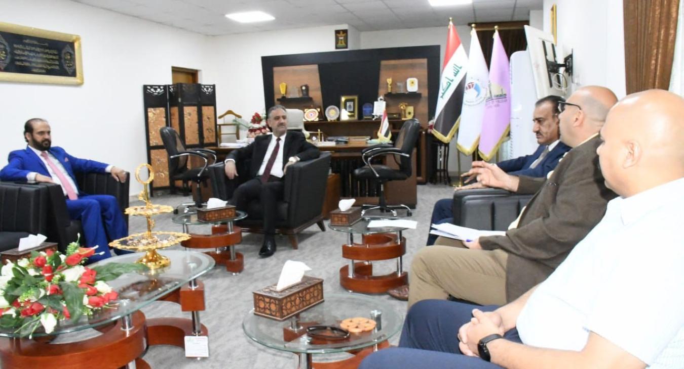 The President of Fallujah University receives a delegation that includes members of the Monitoring and Early Warning Committee in Fallujah District